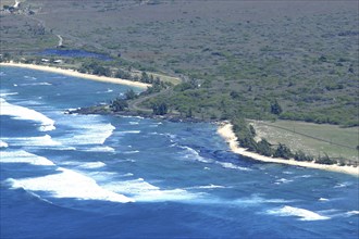 USA, Hawaii, Molokai, Kalaupapa. Aerial view looking down on green coastline with sandy beaches