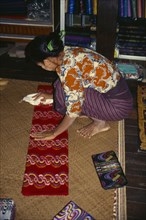MYANMAR, Amarapura, Silk lungi vendor .