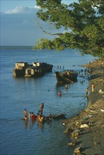 MYANMAR, Bagan, Boats and people washing in the Irrawaddy River.