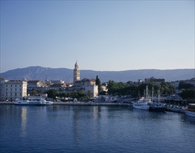 CROATIA, Split, The harbour with boats moored at the harbour wall and the town behind