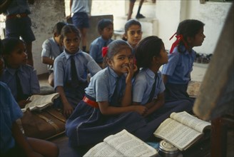 INDIA, Rajasthan, Sisarma Village, Pupils in uniform in classroom of village school.