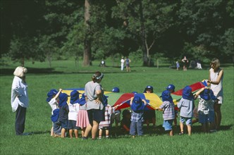 AUSTRALIA, New South Wales, Sydney, Balmoral.  School children in sunhats playing game outside