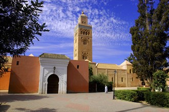 MOROCCO, Marrakech, Koutoubia Mosque entrance gate and minaret with passing man
