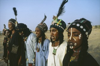 NIGERIA, Tribal People, Woodabe tribesmen dance the Yahe with traditionally painted faces.