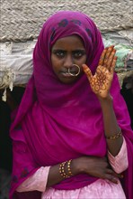 SUDAN, Gadem Gafriet Camp, Beni Amer nomad woman with henna painted hand for marriage.