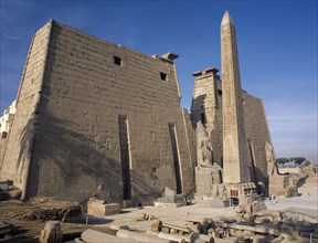 EGYPT, Nile Valley, Luxor, Luxor Temple. Obelisk and statue of Ramses II