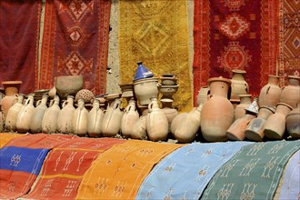 MOROCCO, Marrakech, Display of colourful cloths and ceramics for sale