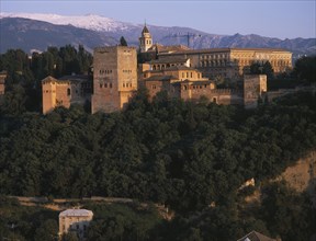 SPAIN, Andalucia, Granada, Alhambra Palace seen from Mirador San Nicolas in evening light with