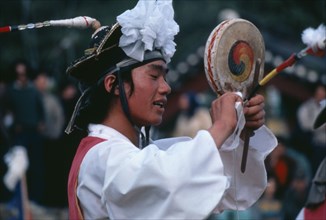 SOUTH KOREA, Arts, Farmers Dance.  Dancer performing fast Chwado-Ko with ribbons on head-dress