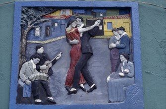 ARGENTINA, Buenos Aires, La Boca.  Painted tableau of tango dancers in the old port district.