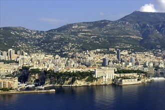 MONACO, Cote d Azur, Monte Carlo, Aerial view from the sea toward the coastal city and hills beyond