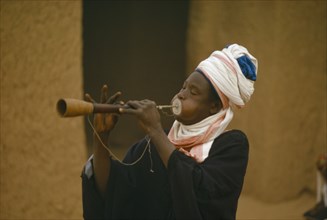 NIGERIA, Katsina, Musician playing traditional flute at the Sallah day celebrations marking the end