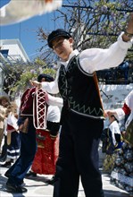 GREECE, Cyclades Islands, Amorgos, Langada. Boy in costume performing traditional Greek dancing