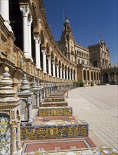 SPAIN, Andalucia, Seville, Plaza de Espana. View along colonnade and seats toward the Central
