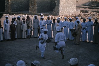 OMAN, People, Traditional dancing watched by group of men and children