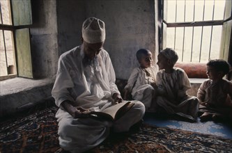 OMAN, Religion, Education, Children studying the Koran with Islamic teacher