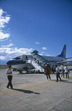 CHINA, Yunnan, Dali, Domestic aircraft on runway with passengers disembarking.