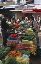 CHINA, Yunnan , Kunming, Covered food market with displays of fresh vegetables.