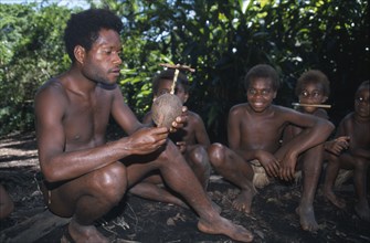 PACIFIC ISLANDS, Melanesia, Vanuatu, Tanna.  Kastom traditional village tribesman and children.