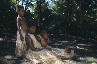 PACIFIC ISLANDS, Melanesia, Vanuatu, Tanna.  Kastom traditional village tribeswoman and children.