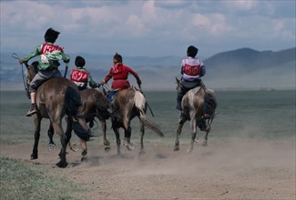 MONGOLIA, Horses, National Day horse race with boy jockeys racing across the plains