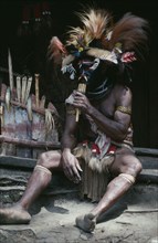 PAPUA NEW GUINEA, Southern Highlands, Near Tari, Paya or traditional healer sitting down