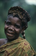 CONGO, Tribal People, Pygmy woman wearing civet skin hat.  Portrait.