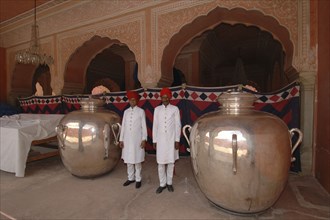 INDIA, Rajasthan, Jaipur, At the Jaipur city palace two guards dressed in white with red turbans