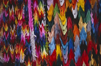 JAPAN, Honshu, Hiroshima, Peace Memorial Park. Mass of multi coloured origami cranes at the