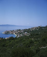 CROATIA, Dalmatia, Igrane, View over coastal town and bay with Hvar Island in the distance