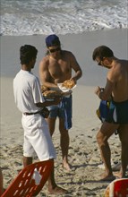 CUBA, Matanzas Province, Varadero, Man selling pizza to tourists on the beach