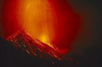 ITALY, Sicily, Volcano Stromboli erupting at night.
