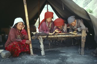 AFGHANISTAN, Reilgion, Islam, Group of Kirghiz children inside tent studying the Koran.
