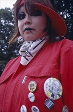 JAPAN, Honshu, Tokyo, Harajuku District. Portrait of young teenage girl wearing a red jacket and