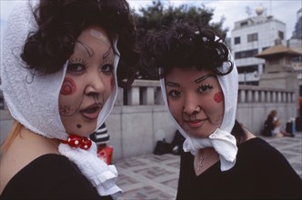 JAPAN, Honshu, Tokyo, Harajuku District. Portrait of two young teenage girls wearing theatrical