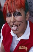 JAPAN, Honshu, Tokyo, Harajuku District. Portrait of a teenage girl wearing cat whisker makeup with