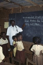 GHANA, West, Education, Teacher and children in primary school studying environmental issues.