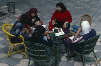 EGYPT, Cairo Area, Cairo, Group of women sitting together in courtyard at The University of Cario.