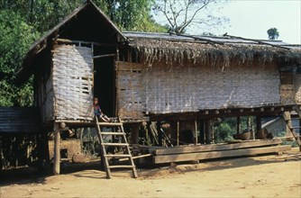 LAOS, Housing, Thatched house raised on stilts in small village up river from Luang Prabang.