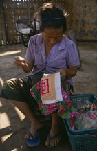LAOS, Craft, Hmong woman embroidering textile