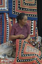 LAOS, Vientiane, Woman embroidering traditional textile