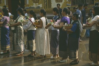 LAOS, Vientiane, Line of young women with offerings for the Awk Phansaa festival.
