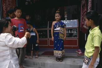 LAOS, Luang Prabang, Little girl in traditional dress waiting to have her photograph taken at New