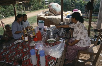 LAOS, Vientiane, Two girls eating at Mrs Tongs roadside noodle stall