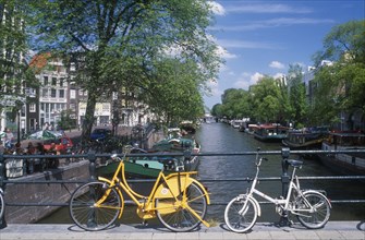 HOLLAND, Noord, Amsterdam, Bicycles leaning against the railings of a bridge over the Keizersgracht