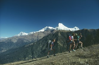 NEPAL, Landscape, Trekkers above Ghorepani with Annapurna in the distance