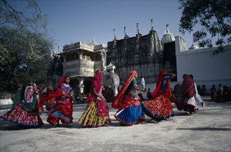 INDIA, Rajasthan, Sadri, Tribal girls in colourful dresses dancing on Holi Day