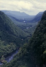 GUYANA, Amazon, Kaieteur NP, River valley with tropical forest covering steep sides