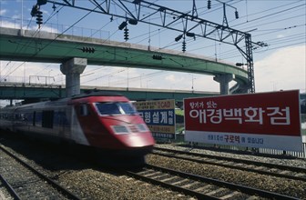 SOUTH KOREA, Seoul, High speed train passing through station in city suburbs