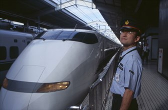 JAPAN, Honshu, Kyoto, Bullet train aka Shinkansen pulling into the station platform with train